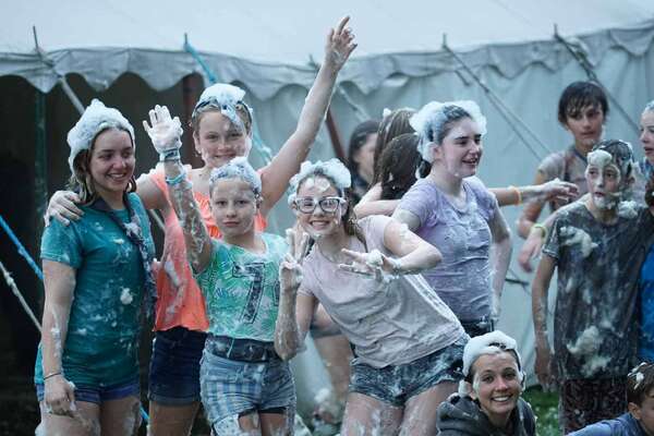 young people enjoy foam party on camp